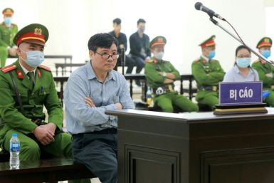This picture taken and released by the Vietnam News Agency on March 9, 2020 shows Vietnamese blogger Truong Duy Nhat sitting in a courtroom during his trial in Hanoi