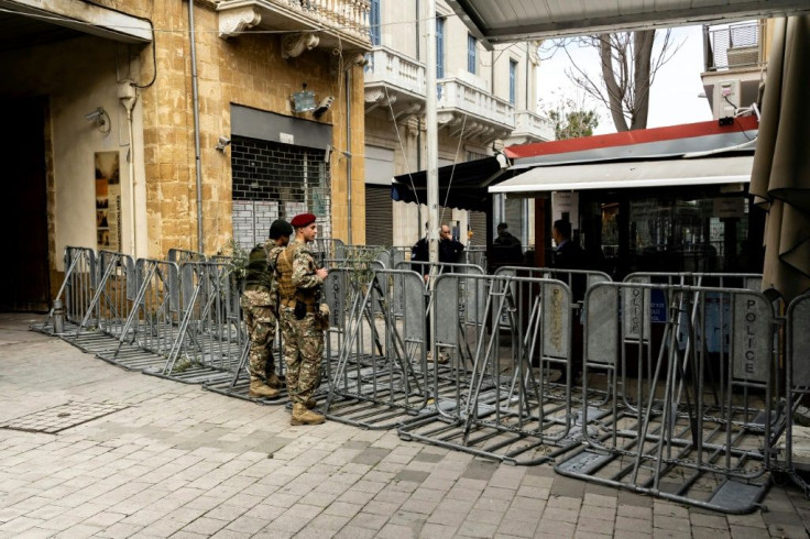 Cypriot soldiers stand guard at the closed Ledra crossing checkpoint in the old city of the capital Nicosia