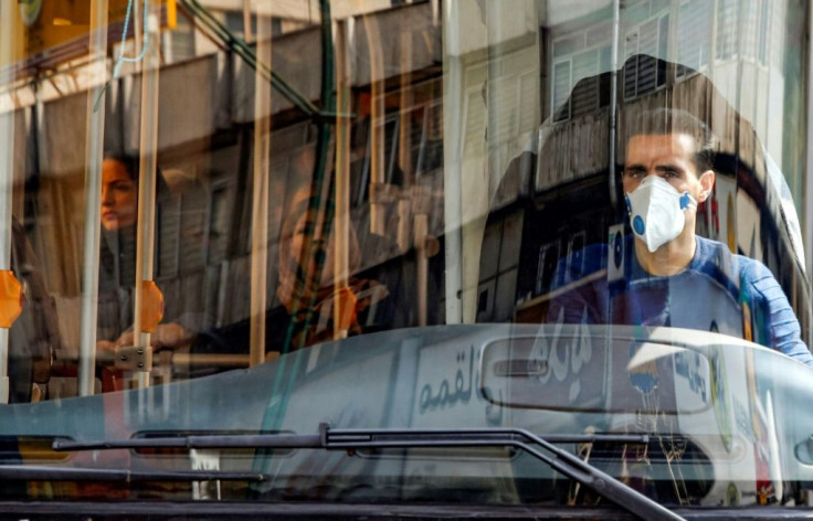 A Tehran bus driver wearing a protective mask as a precaution against coronavirus