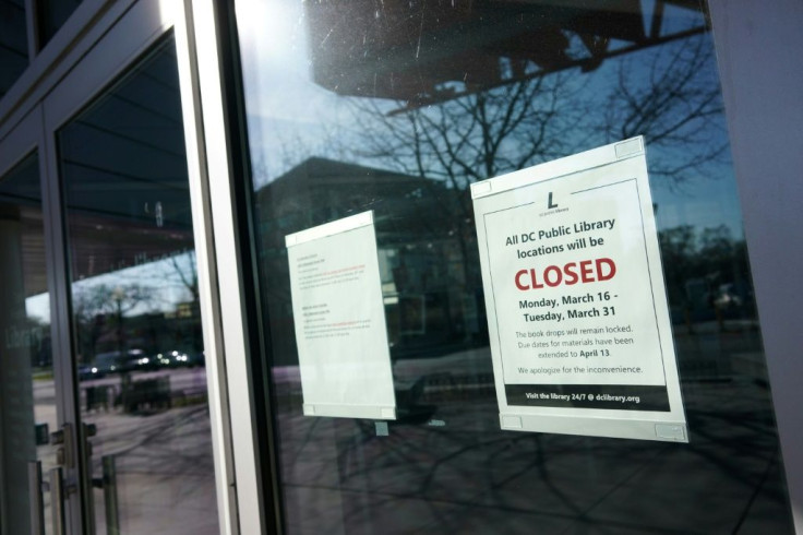 A "closed" sign is viewed on the door of the Tenley/Friendship DC Public Library on March 16, 2020, in Washington, DC