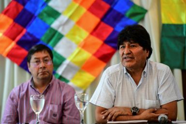 Former Bolivia president Evo Morales (right) sits alongside the presidential candidate for his Movement for Socialism party, Luis Arce