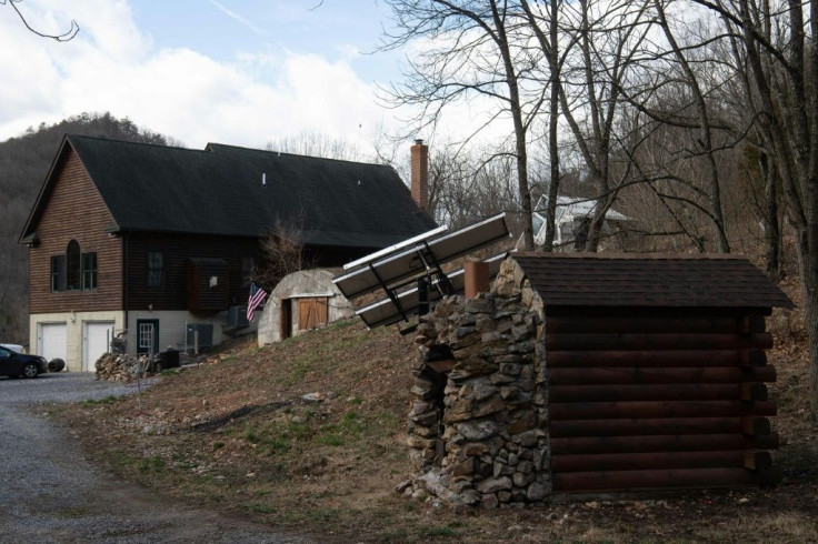 A smokehouse, solar panels, a greenhouse and the main building are seen at Fortitude Ranch in Mathias, West Virginia