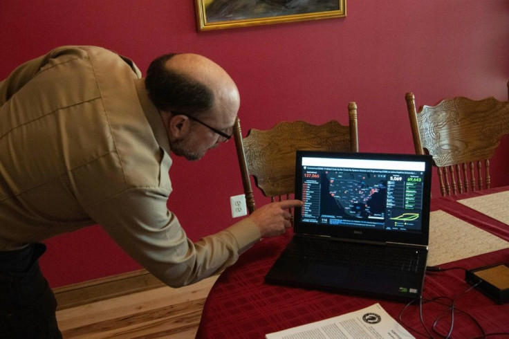 Fortitude Ranch Chief Operating Officer Steve Rene tracks a map of the spread of the coronavirus -- of which no cases are near the survivalist camp in Mathias, West Virginia
