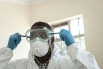Virus threat: A lab technician gears up for visiting a quarantine ward at the Kenyatta National Hospital in Nairobi