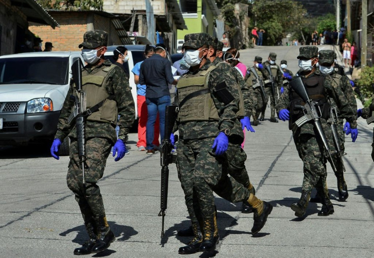 Soldiers assist health personnel in Tegucigalpa, Honduras on March 17, 2020 after two new cases of the new coronavirus were confirmed