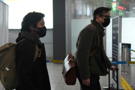Wall Street Journal reporters Josh Chin (right) and Philip Wen walk through Beijing Capital Airport as they are expelled in February 2020 over a controversial headline in an op-ed in the newspaper