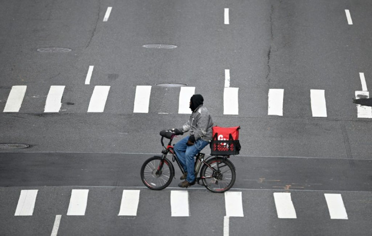 A food delivery man crosses 1st Avenue in Manhattan on March 17, 2020  in New York City