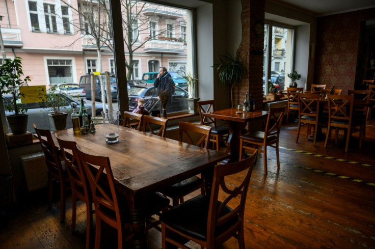 Empty tables are seen in a restaurant in Berlin's Prenzlauer Berg district