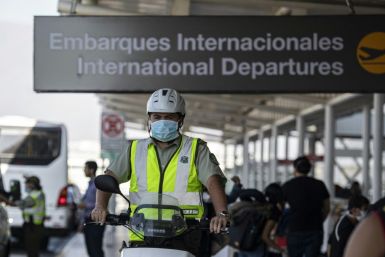 A policeman wears a face mask to prevent the spread of the new Coronavirus at the Santiago international airport