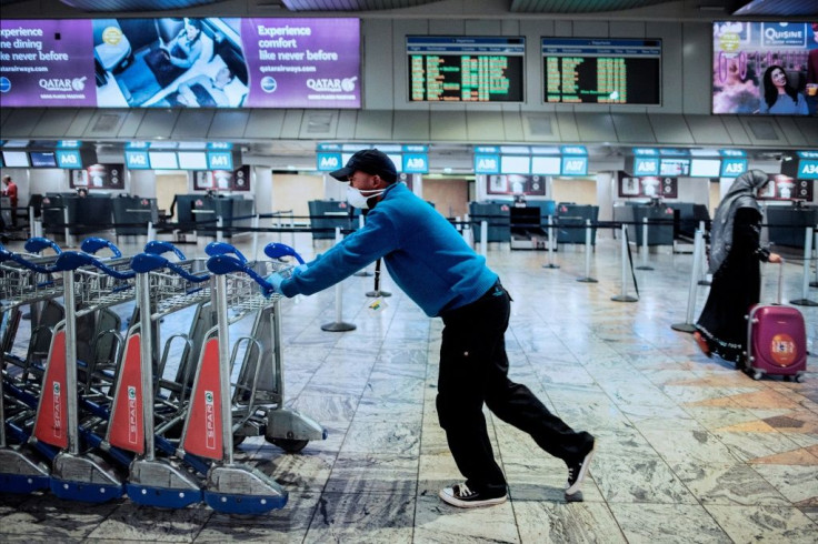 An airport employee wears a face mask as a preventive measure against the COVID-19 coronavirus at the O.R. Tambo international airport in Johannesburg