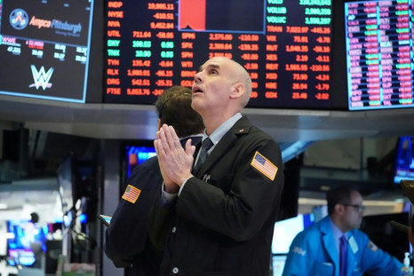 Traders work on the floor at the opening bell at the New York Stock Exchange on March 18