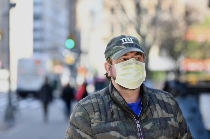 A man wearing a face mask walks in New York on March 18