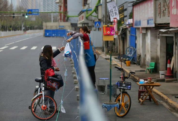 Barriers to stop the spread of the coronavirus in Wuhan have divided communities
