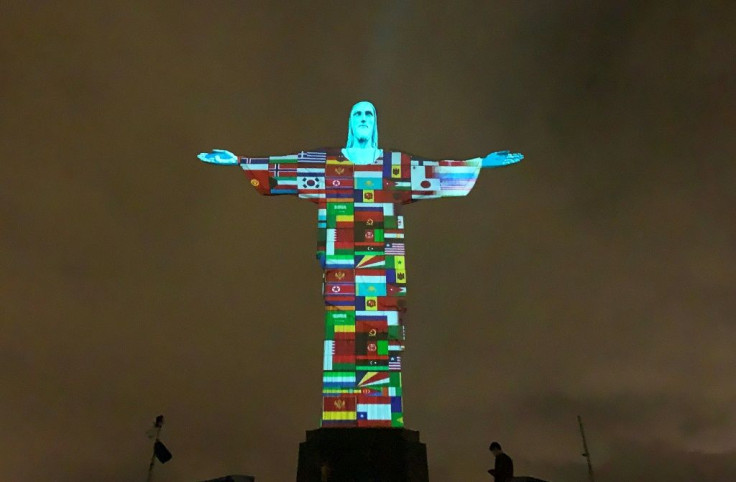 Flags of some countries affected by the coronavirus are projected onto the statue of the Christ Redeemer atop Corcovado hill in Rio de Janeiro, Brazil