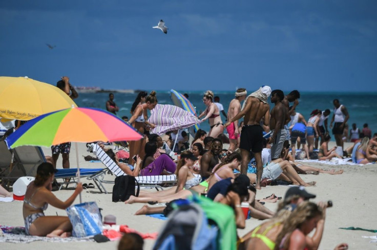 Tourists enjoy Miami Beach, ignoring recommendations to keep their distance as coronavirus grips the globe