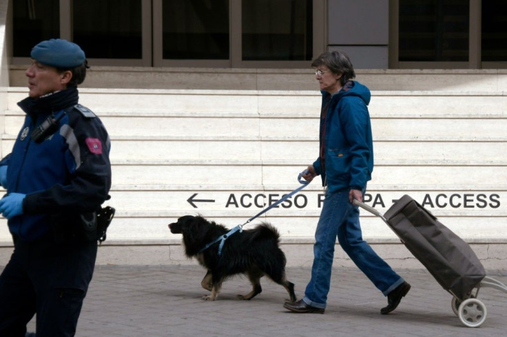 Have dog, will travel -- a canine companion helps this woman as she rushes out to load her shopping trolley in Madrid