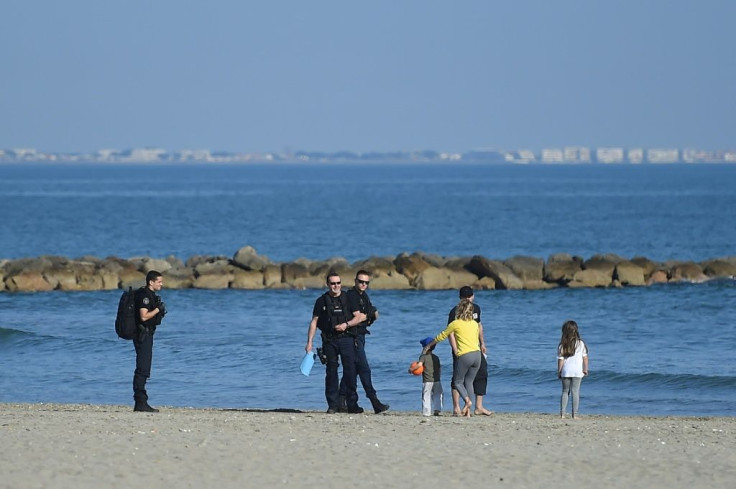 Inhabitants of rural areas are afraid people fleeing big cities such as Paris will widen the virus spread and put pressure on scarce local resources -- here police control a family on a beach in the southern resort of Carnon