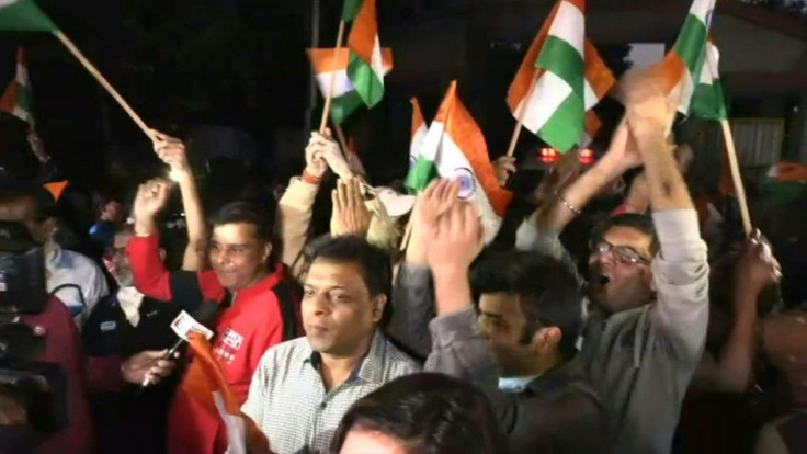 People cheer outside a Delhi prison after four 2012 bus gang-rapists are hanged