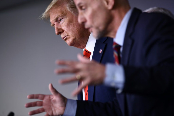 US President Donald Trump listens to FDA Commissioner Stephen Hahn (R) speak on the latest developments of the coronavirus outbreak