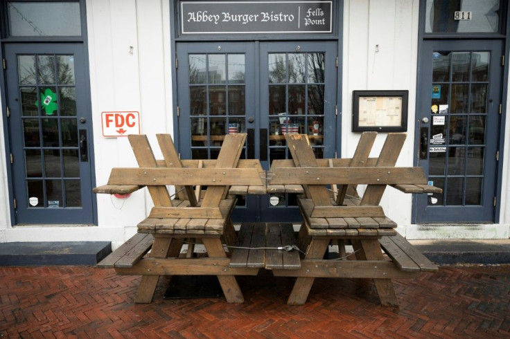 Picnic tables block the closed doors of Abbey burger Bistro in Baltimore, after Maryland Governor Larry Hogan banned on-premise drinking and dining at restaurants