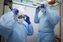 Malian researchers get suited up to conduct a coronavirus test at a lab in Bamako