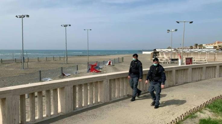 Italian police enforce the closure of beaches in Ostia, outside of Rome, as part of one of the last measures put in place to face the new coronavirus emergency. Italy reported a record 627 new coronavirus deaths Friday and saw its world-topping toll surpa