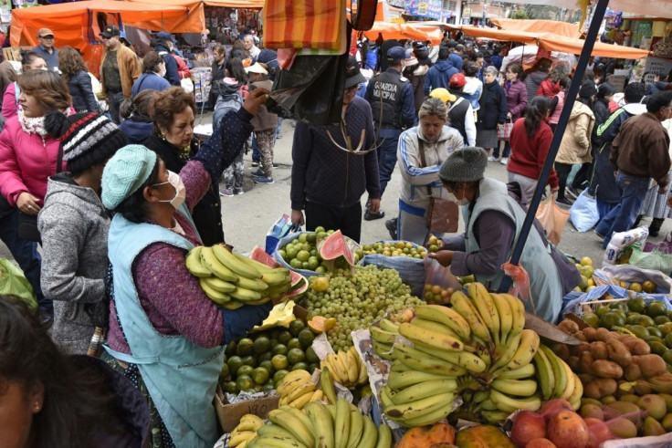 Shoppers crowd a market in La Paz after Bolivian interim President Jeanine Anez announced the country was going to be placed under a complete quarantine to stop the spread of the novel coronavirus