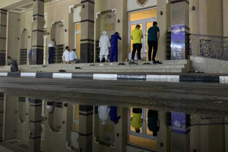 Muslim worshippers pray in front of a Dubai mosque, one of many places of worship across the region to close its doors