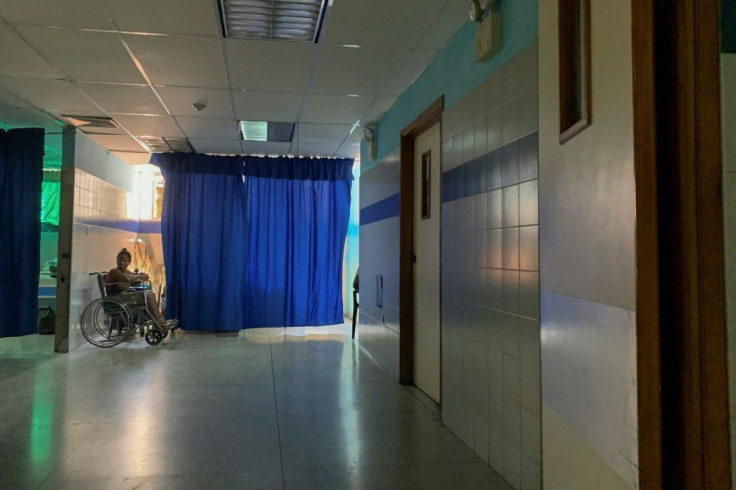 A patient in a wheelchair waits on the emergency ward of the hospital in Guiria Venezuela