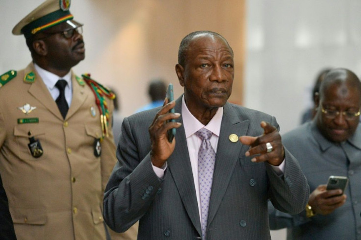 Alpha Conde, centre, became Guinea's first democratically-elected president in 2010 - today, critics say he has taken the well-worn path of authoritarianism