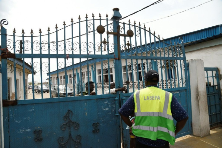 Worshippers clustered at the gate of Makoko's Celestial Church of Christ only to find policemen handing out fliers on the dangers of the virus