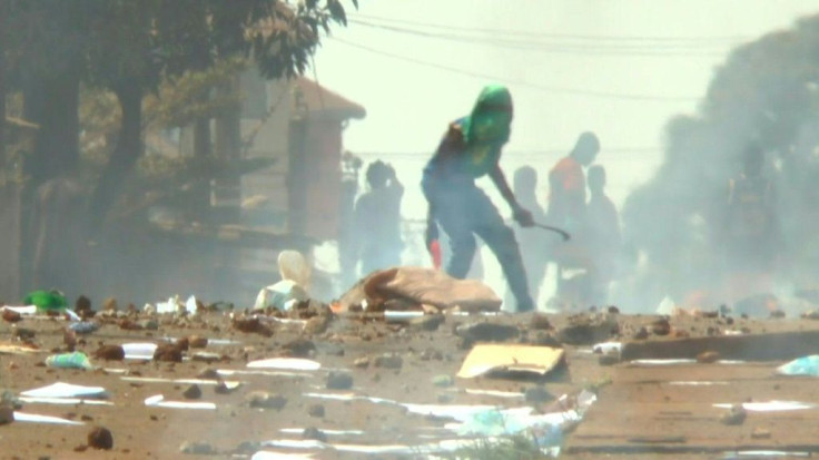 IMAGESOne person is killed and several injured as police fired tear gas in clashes with protesters in Guinea at the start of a bitterly-disputed referendum that critics say is a ploy by the president to stay in power.