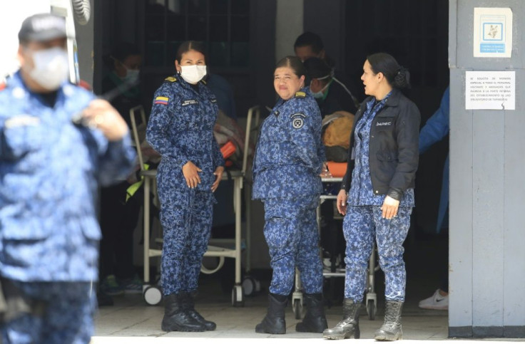 Prison guards stand next to injured inmates after rioting at Bogota's Modelo prison, on March 22, 2020