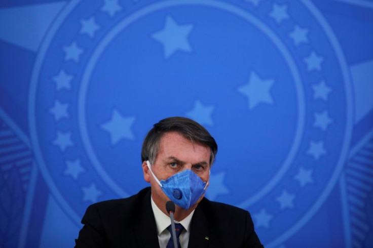 Brazil's President Jair Bolsonaro, pictured wearing a face mask during a press conference about the coronavirus pandemic on March 20, 2020, has played down the crisis