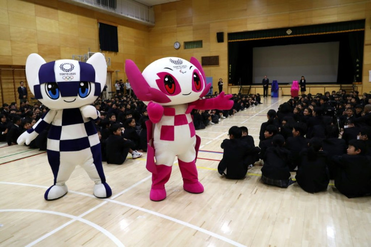 Olympic and Paralympic mascots Miraitowa (left) and Someity  delight schoolchildren on a visit to a primary school in Tokyo