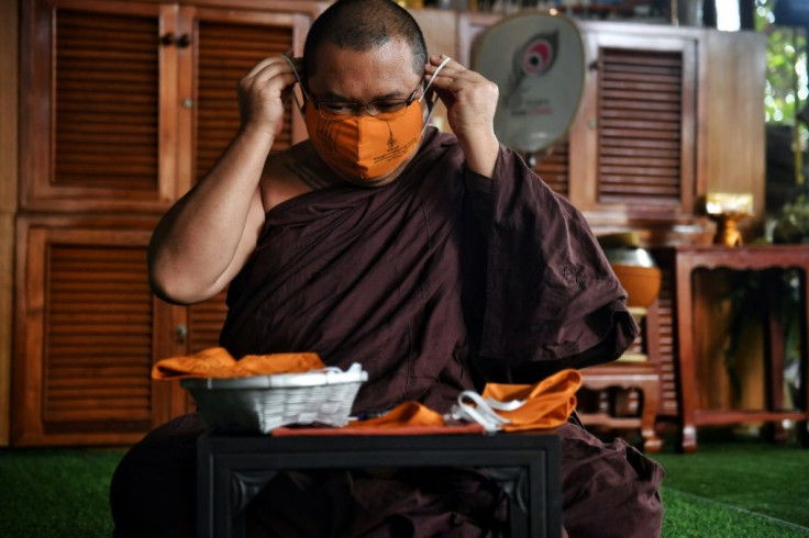 Thai monks are weaving recycled synthetic fibres with cotton into piles of saffron-coloured masks