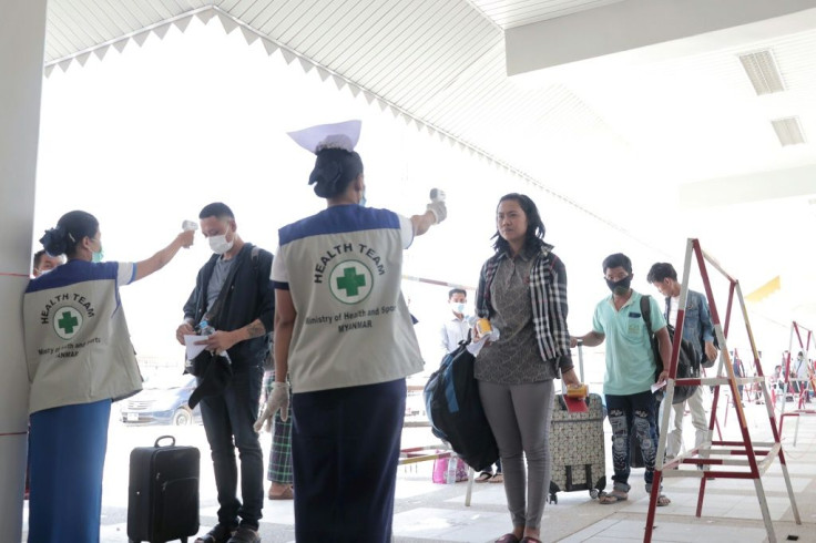 People entering Myanmar have their temperatures checked amid concerns over the spread of the COVID-19 coronavirus at the immigration post in Myawaddy, near the Thai border