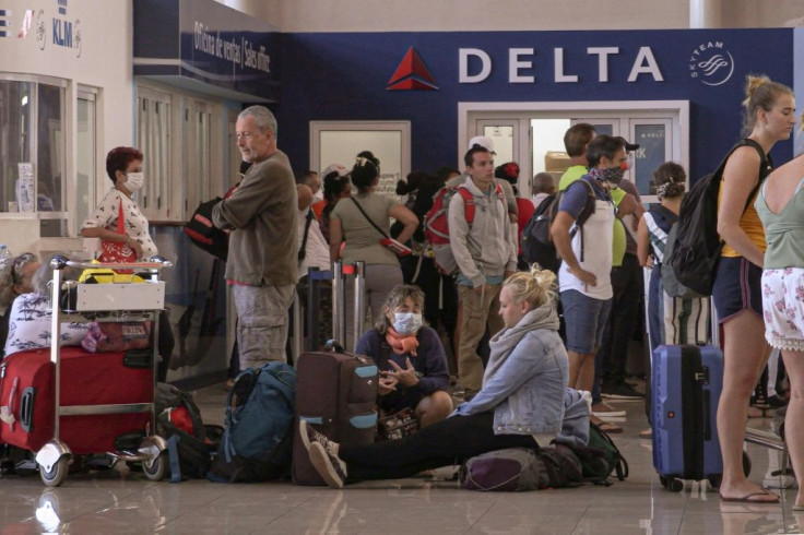 Stranded passengers line up looking for a flight to return to their countries, at Havana's Jose Marti airport