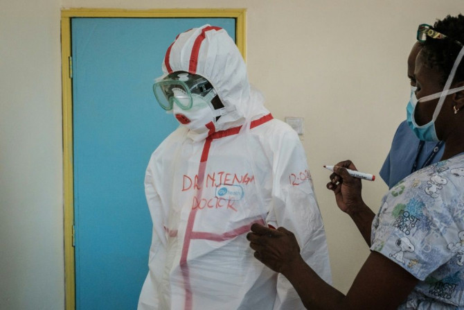 Protection: A doctor gets suited up for visiting a quarantine ward at Kenyatta National Hospital in Nairobi