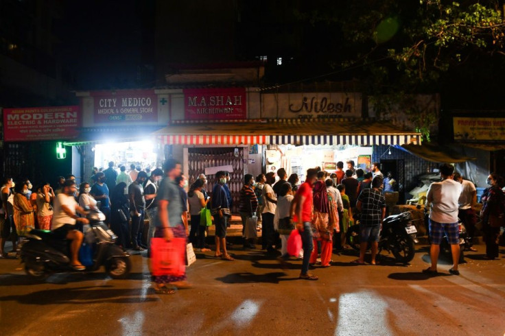 People line up outside stores in Mumbai to buy groceries on March 24 following Prime Minister Modi's lockdown announcement