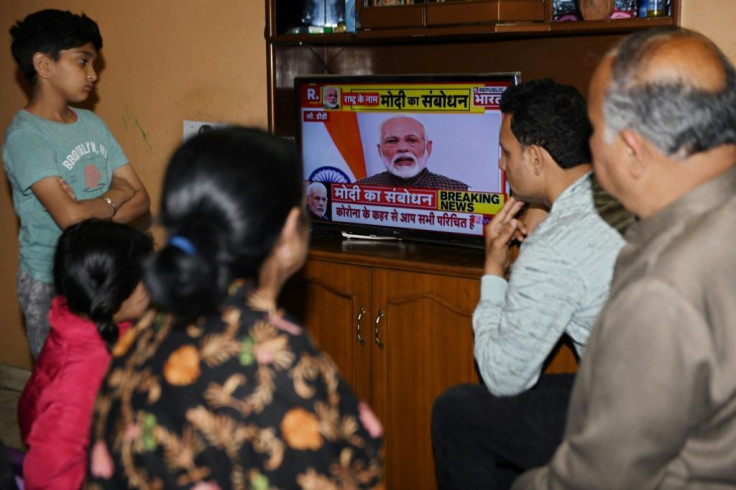 A familyÂ watches Prime Minister Modi's address to the nation at their home in Amritsar