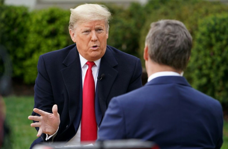 US President Donald Trump (L) speaks with anchor Bill Hemmer during a Fox News virtual town hall meeting from the Rose Garden of the White House in Washington, DC, on March 24, 2020