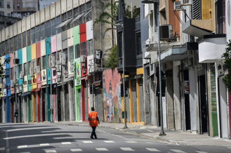 A man walks on a popular shopping street in downtown Sao Paulo on March 24