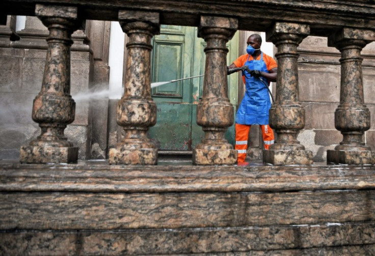 A municipal worker disinfects a church entrance in Rio de Janeiro on March 24