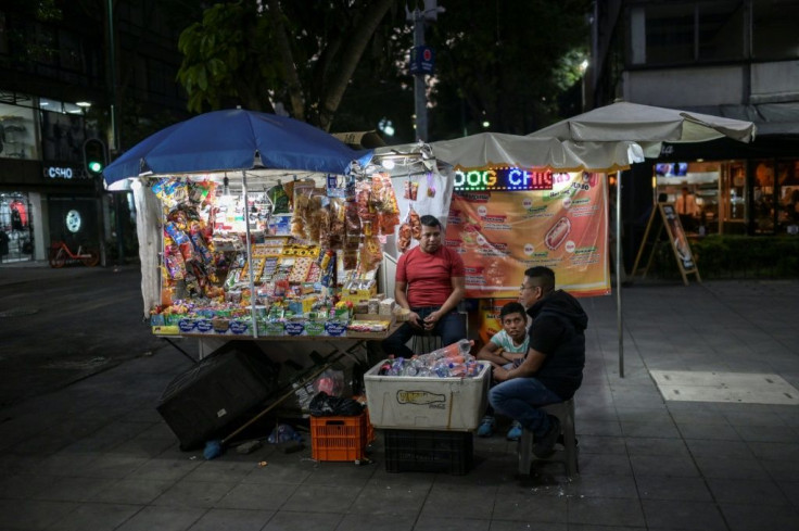 Street vendors in Mexico City wait for customers, but they are few and far between