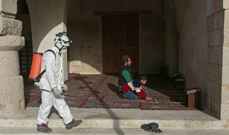 Members of the Syrian Civil Defence (White Helmets) disinfect a mosque in the Syrian city of al-Bab