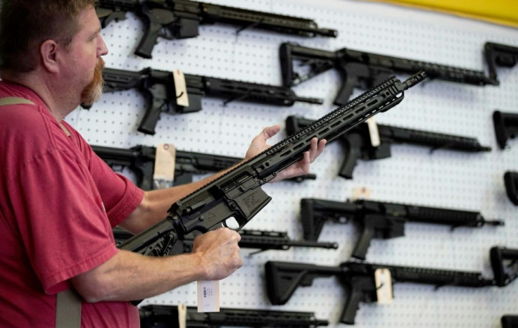 A worker inspects an AR-15 gun at Davidson Defense in Orem, Utah