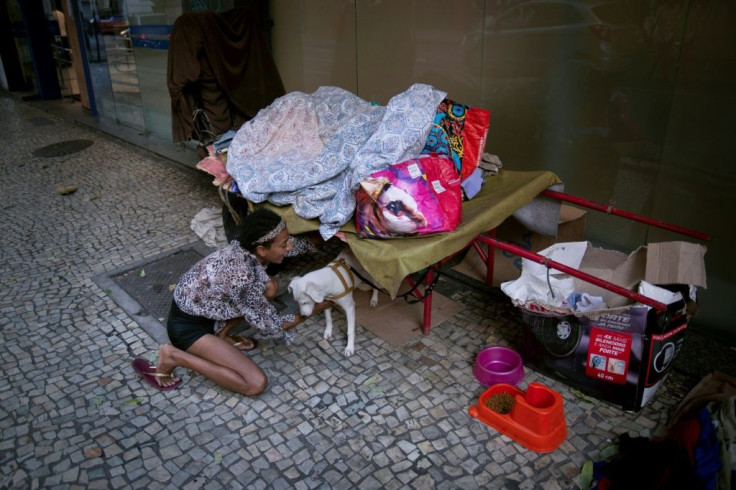 A homeless woman plays with her dog at the Lapa neighbourhood in Rio de Janeiro during the coronavirus (COVID-19) outbreak in Rio de Janeiro, Brazil, on March 23, 2020