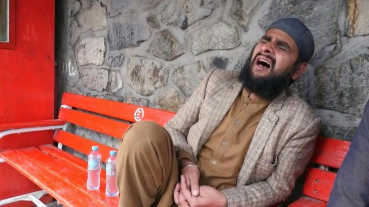 IMAGES People mourn outside hospital after more than 20 people were killed when gunmen stormed a Sikh-Hindu temple in central Kabul in an attack claimed by the Islamic State group.