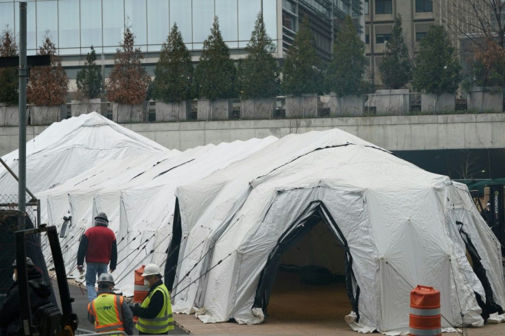 Workers build a makeshift morgue outside of Bellevue Hospital to handle an expected surge in coronavirus victims in New York, the current epicenter of the outbreak in the US